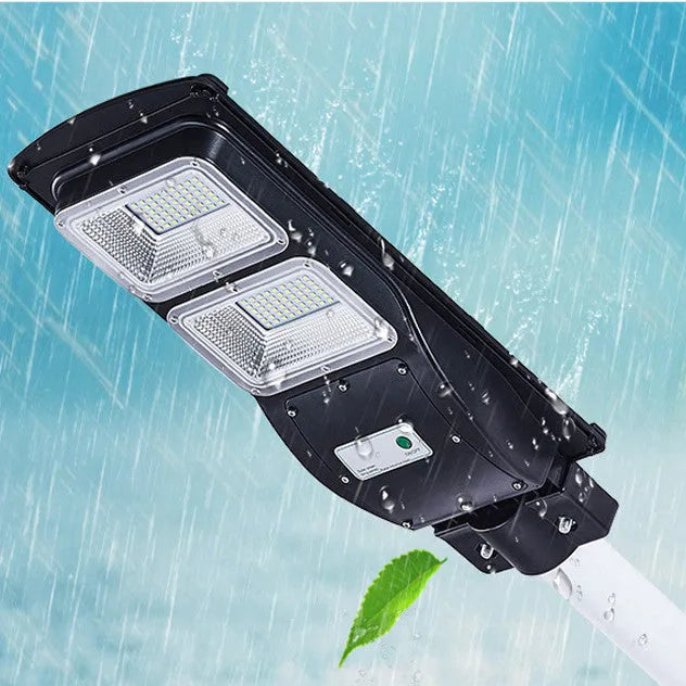 Integrated solar street light with LED panel and remote control for outdoor use.