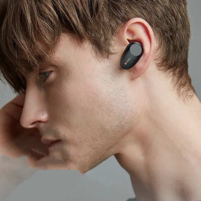 Black wireless Bluetooth headset with charging stand showing type-C port and wireless charging surface