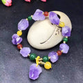 Natural shaped amethyst bead bracelet with fu character element on wrist