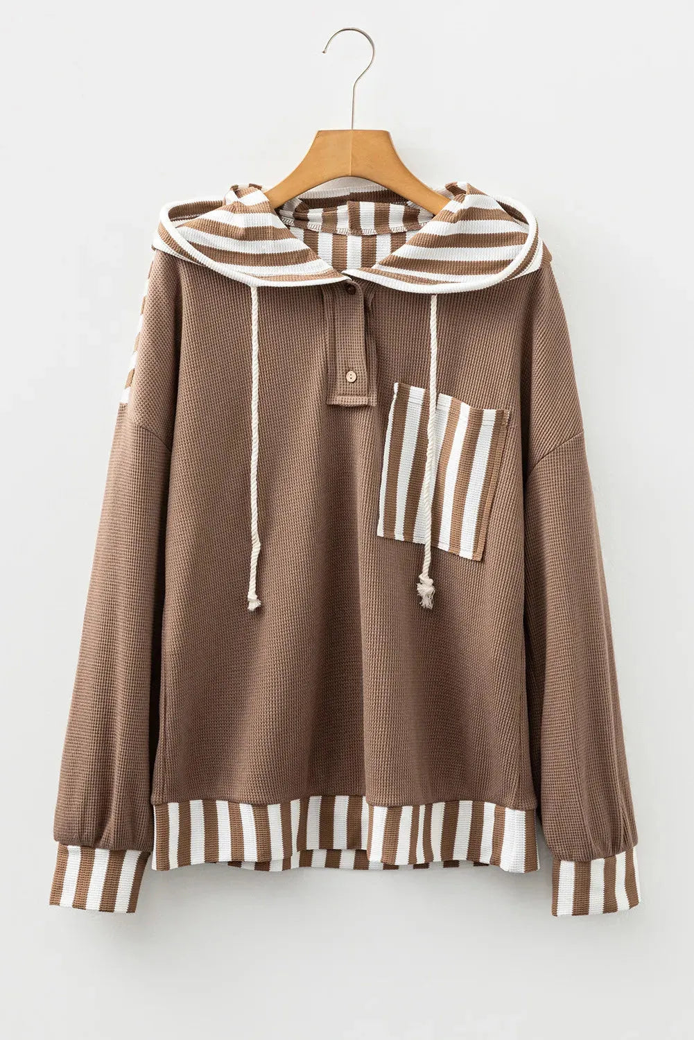 Straw yellow hoodie with striped patchwork design, waffle texture, button neck, and drawstring hood.