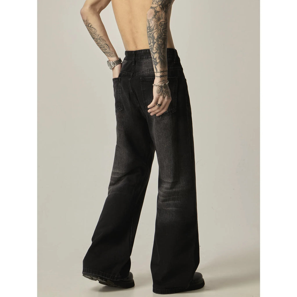 Black loose straight leg retro jeans on a hanger showing zipper fly detail