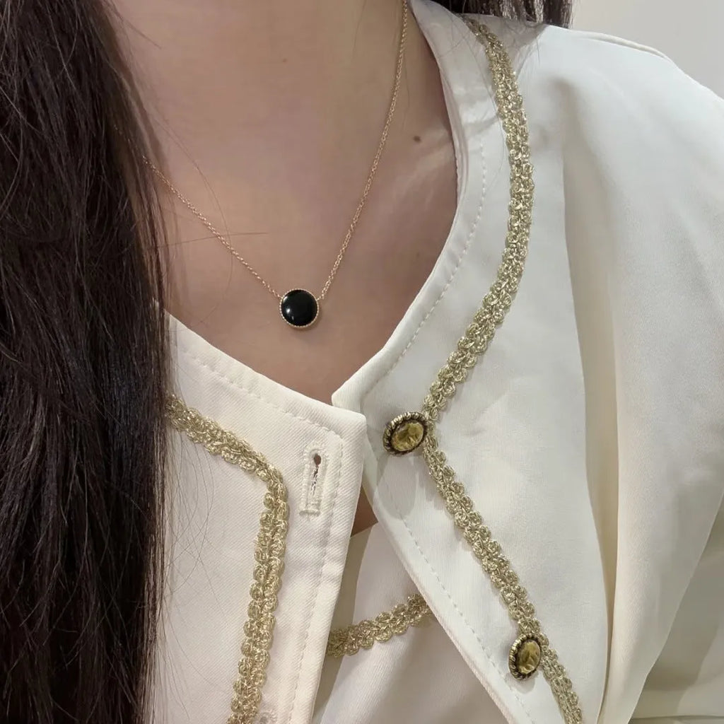 Gold-plated compass necklace for women with round black agate pendant on adjustable curb chain