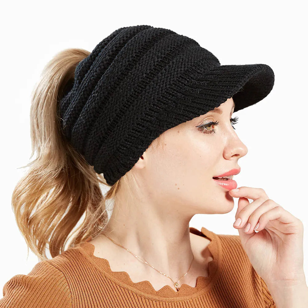 Women's grey knitted beanie with elastic opening at back for ponytail or bun hairstyle