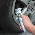 Silver four-in-one digital tyre pressure gauge with safety hammer and emergency light on white background