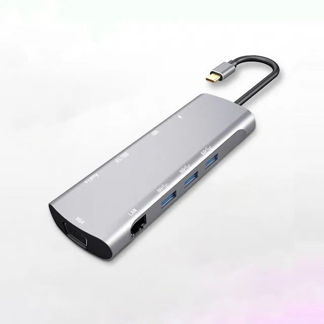 Grey aluminium USB-C docking station showing HDMI, VGA, USB 3.0, PD charging, and card reader ports.