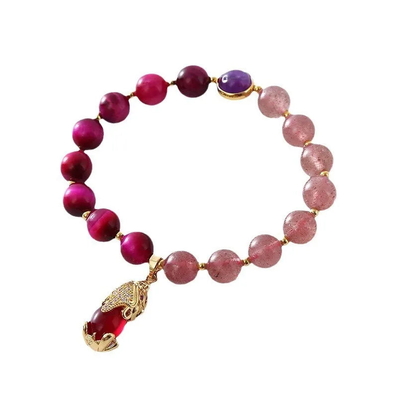 Simple women's bracelet with a strawberry crystal on a black elastic rope.