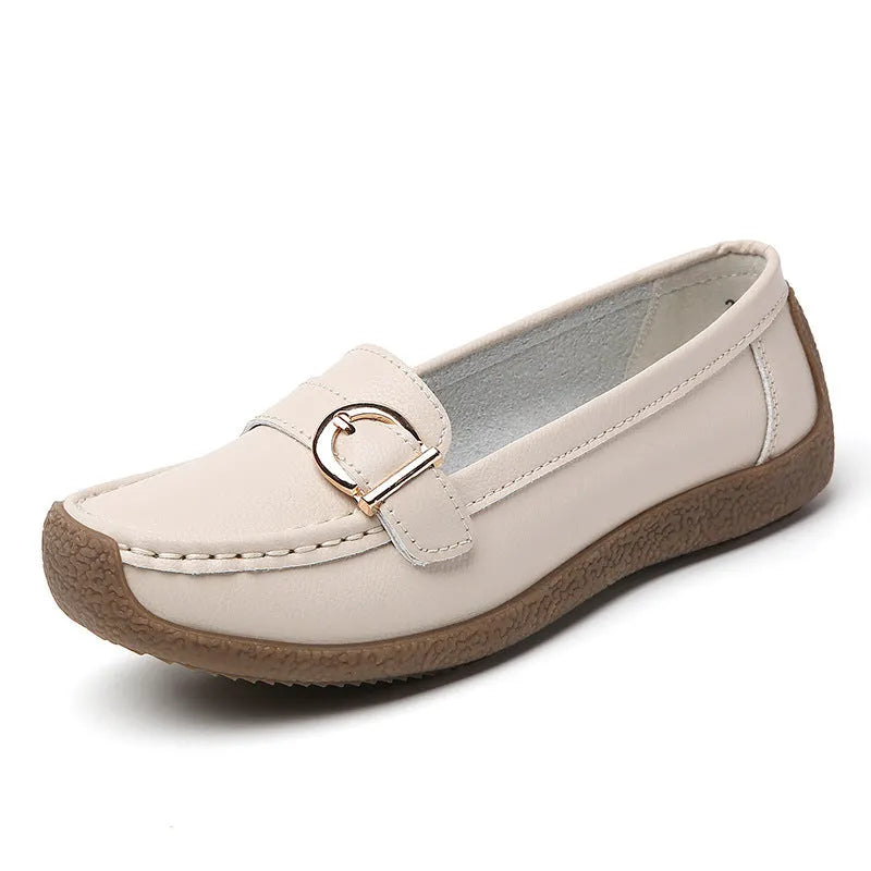 Women's beige casual loafers with round toe, flat heel, and slip-on design on a plain background.