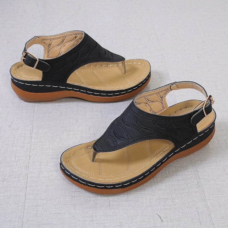 Women's red wedge heel sandals with an adjustable buckle strap on a white background