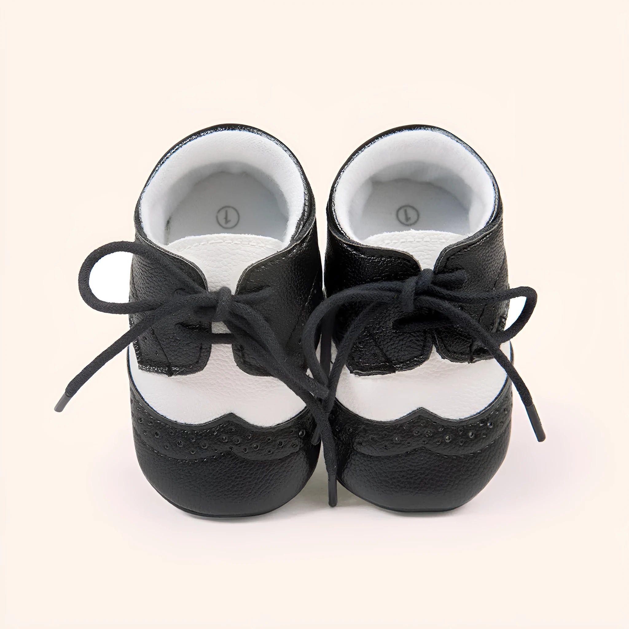 Vintage style soft-soled baby walking shoes for boys in black, grey, light brown, and white.