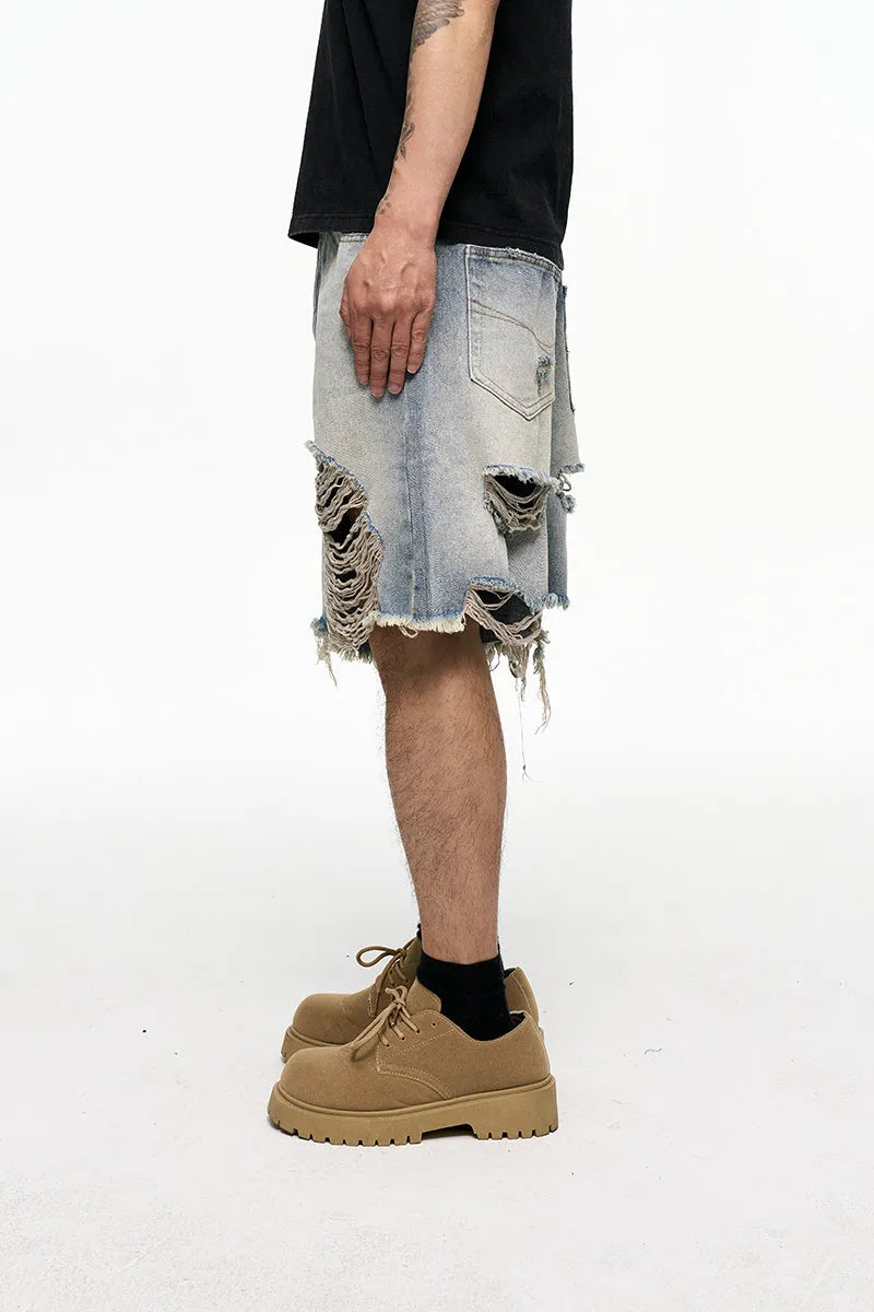 Light blue men's baggy denim shorts with a washed finish and zipper fly on a mid waist.