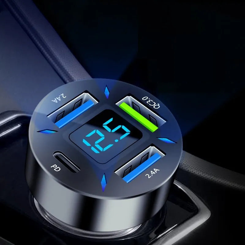 Four-port USB car charger with LED digital display, shown plugged into a vehicle socket.