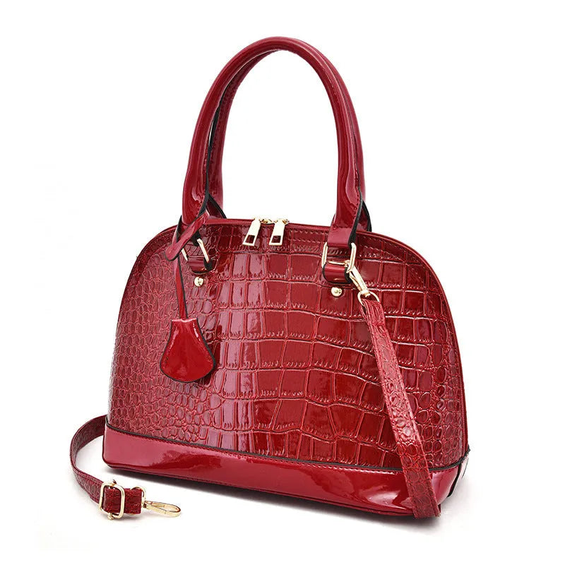 Black shiny PU crossbody bag with shell shape, showing size and polyester lining.