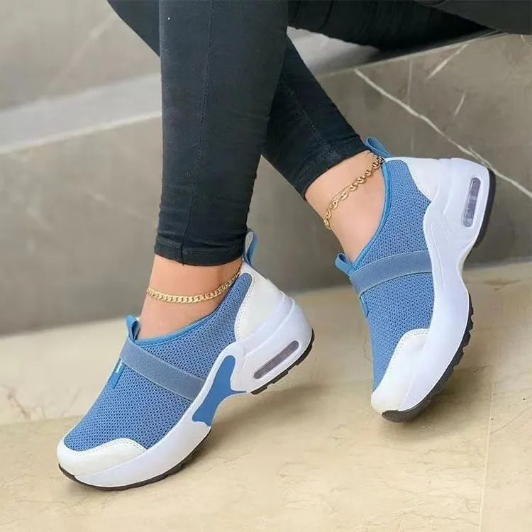 Women's flat mesh sneakers in light grey with a round toe and shallow opening, featuring a non-slip rubber sole.