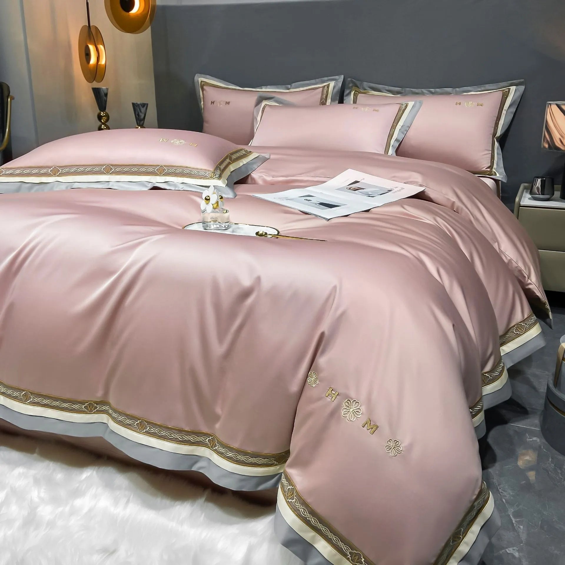 All-cotton light luxury four-piece bedding set with embroidery, available in multiple colours, on a bed