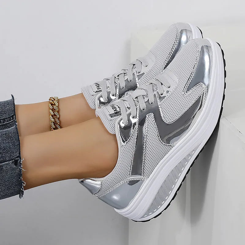 Women's gold platform trainers with mesh upper and cross-strap design showing 3-5cm heel elevation