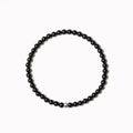 Unisex bracelet with black obsidian, blue San, and agate beads in round and square geometric shapes.