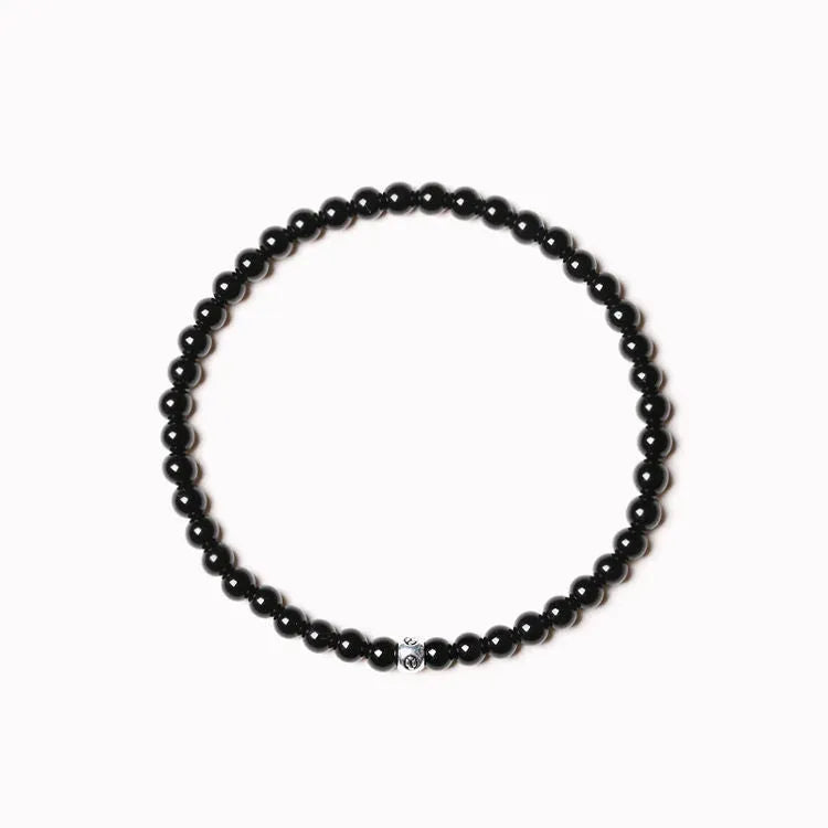 Unisex bracelet with black obsidian, blue San, and agate beads in round and square geometric shapes.