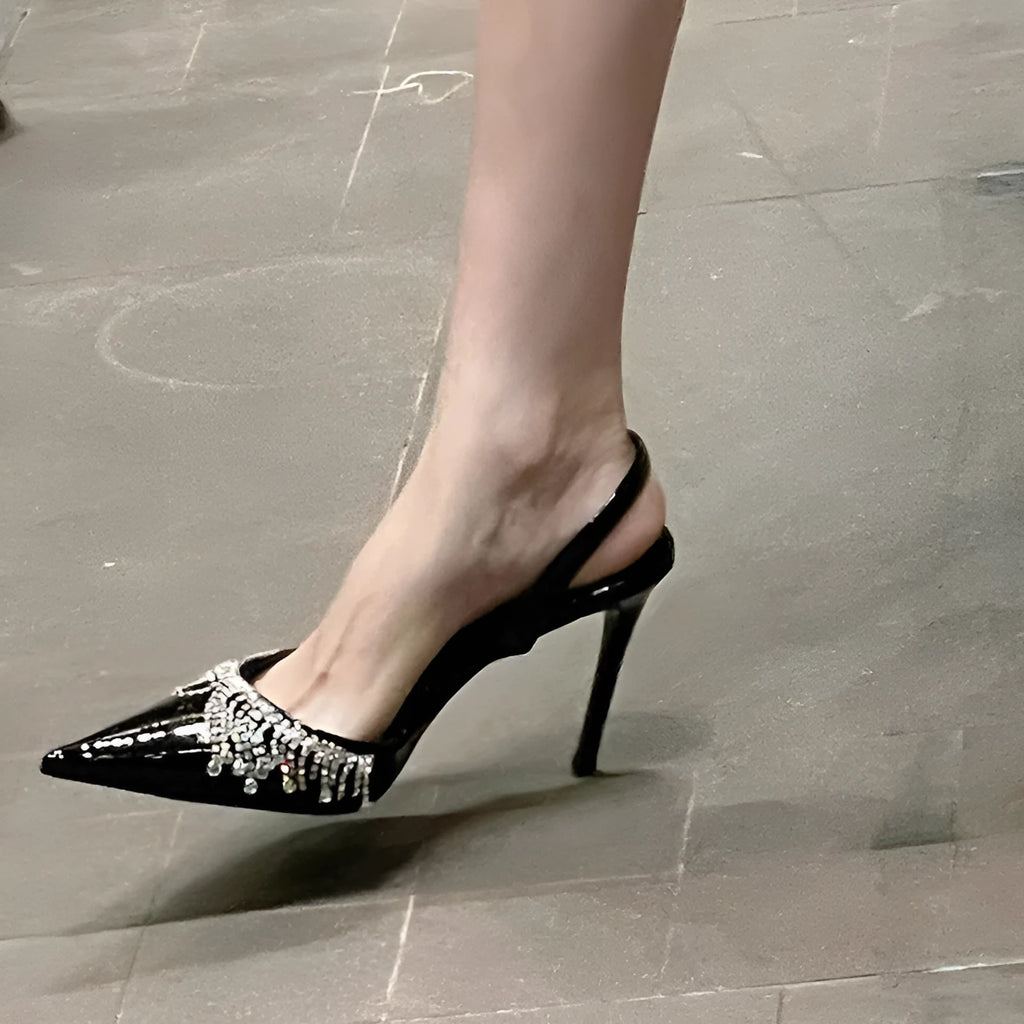 Black women's slingback high heel sandals with pointed toe, 10cm heel, and French tassel rhinestone detail.
