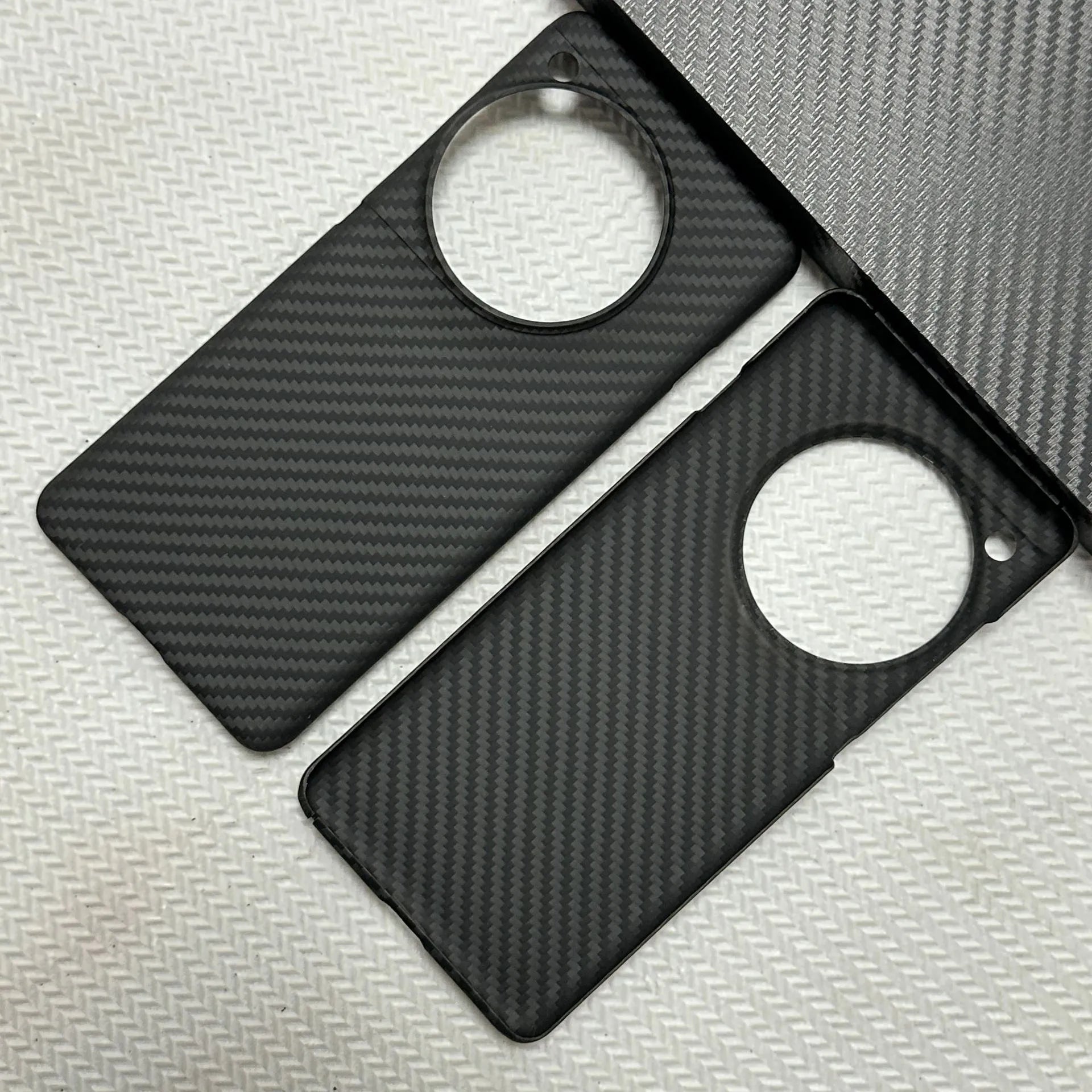 Black hand-woven Kevlar anti-wear phone case for OnePlus 12 with crater texture