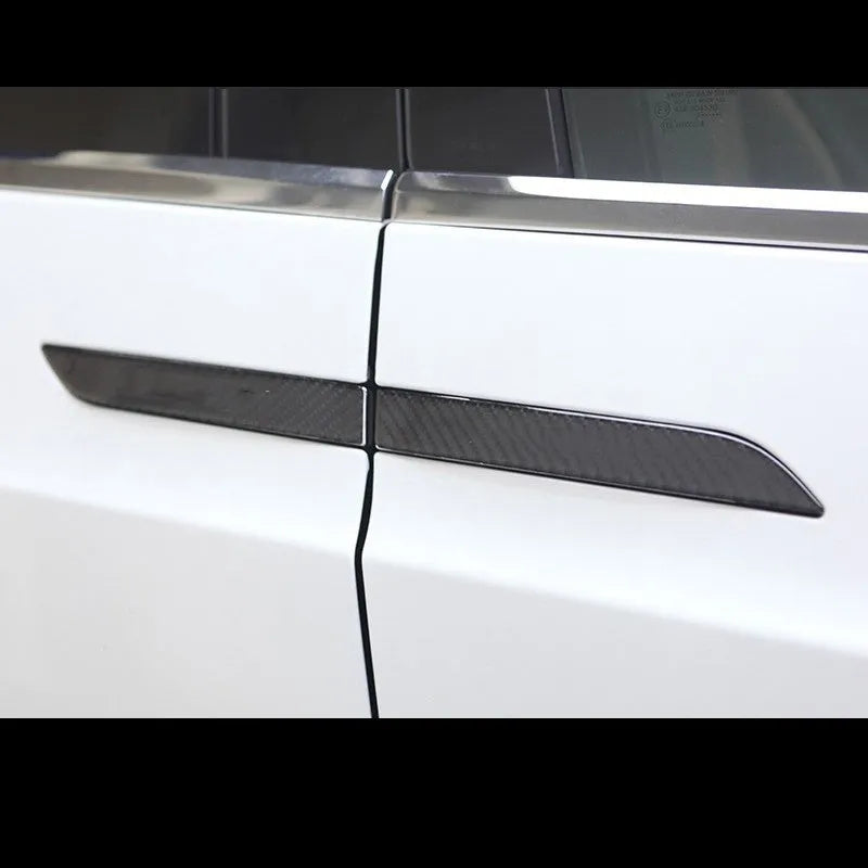 Four carbon fibre adhesive door handle protection patches for a Tesla Model S.