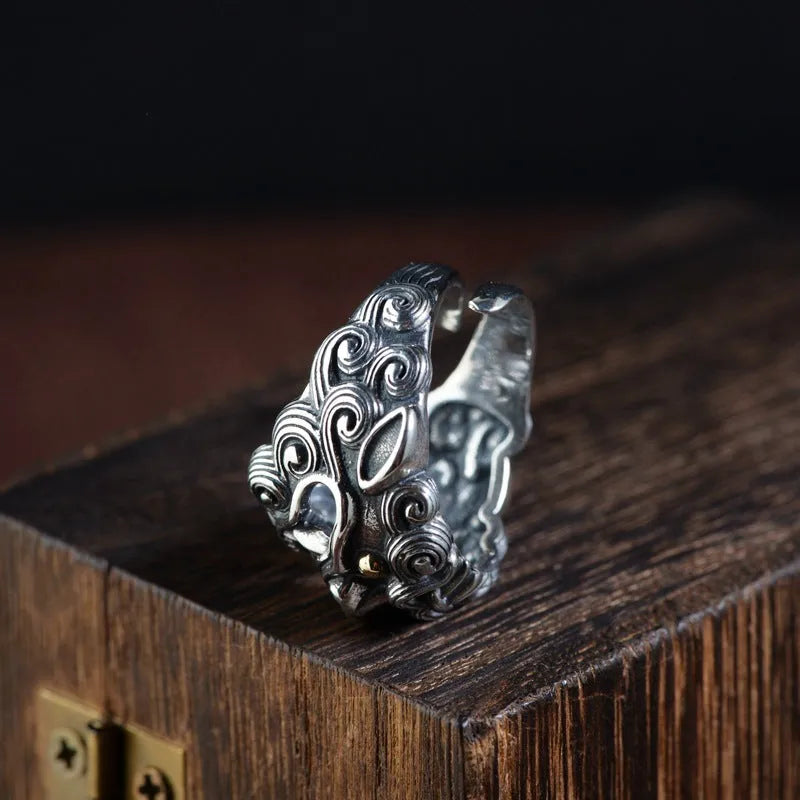 Silver open ring with detailed jibeast animal zodiac pattern showing adjustable retro design