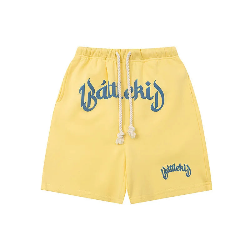 Men's loose grey cotton blend hip hop shorts with a cropped, street-style design on a neutral background.