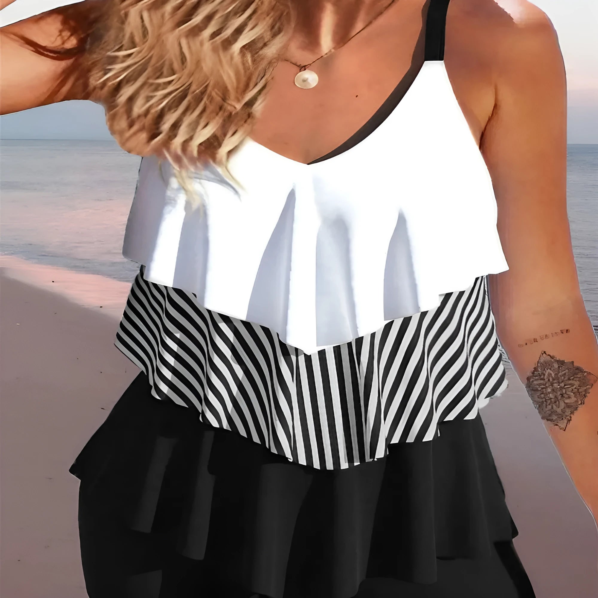 Women's backless bikini swimsuit with spaghetti straps and a ruffle trim.
