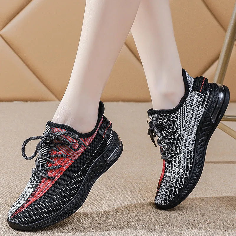 Women's purple low-top lace-up running shoes with round toe and plastic sole on a white background.