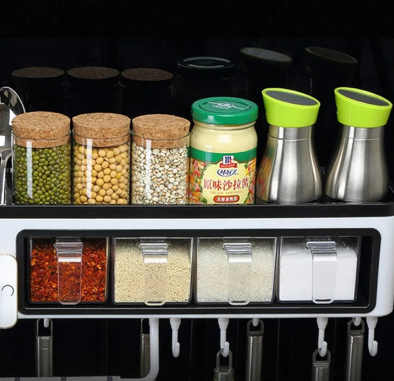 White plastic wall-mounted kitchen storage box with compartments for tools and seasonings