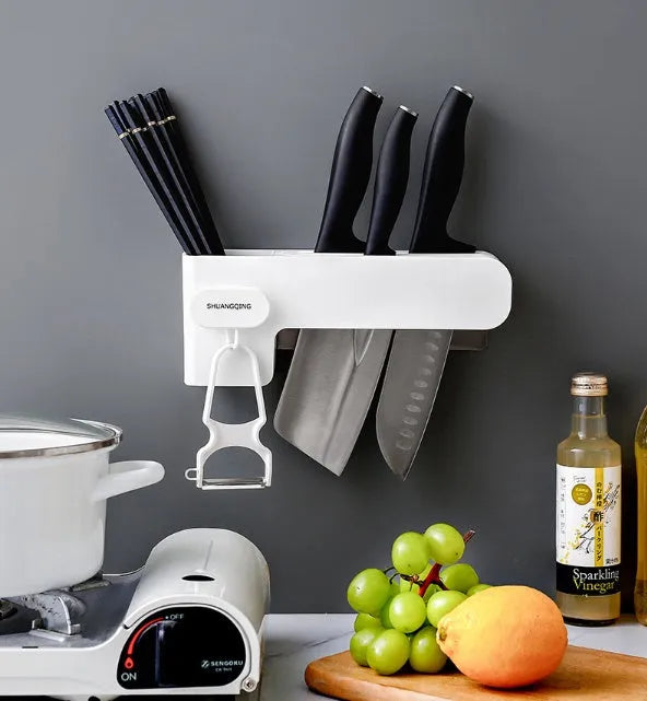 White plastic kitchen knife rack with modern simple design on countertop holding several knives