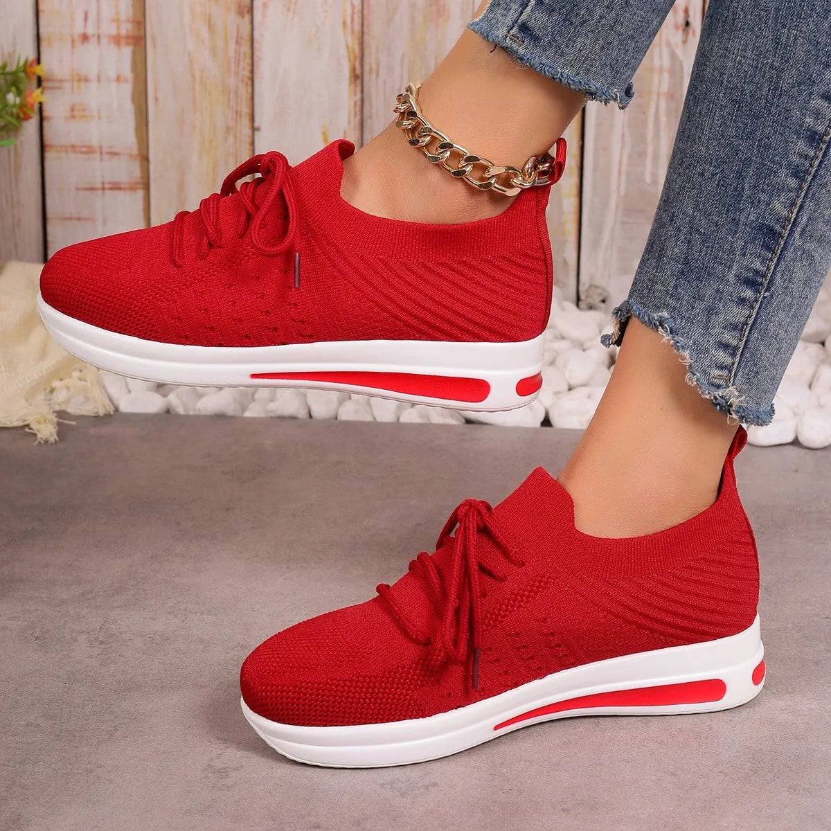 Women's black fly-knit style casual sneakers with lace-up front and low-top design.