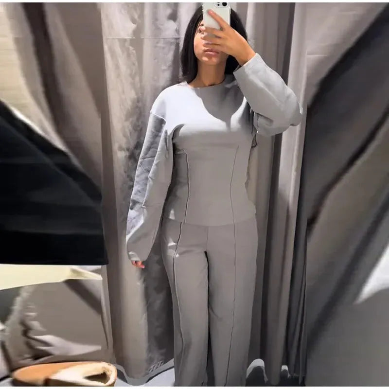 Women's black polar fleece suit set with long sleeve top and wide leg trousers