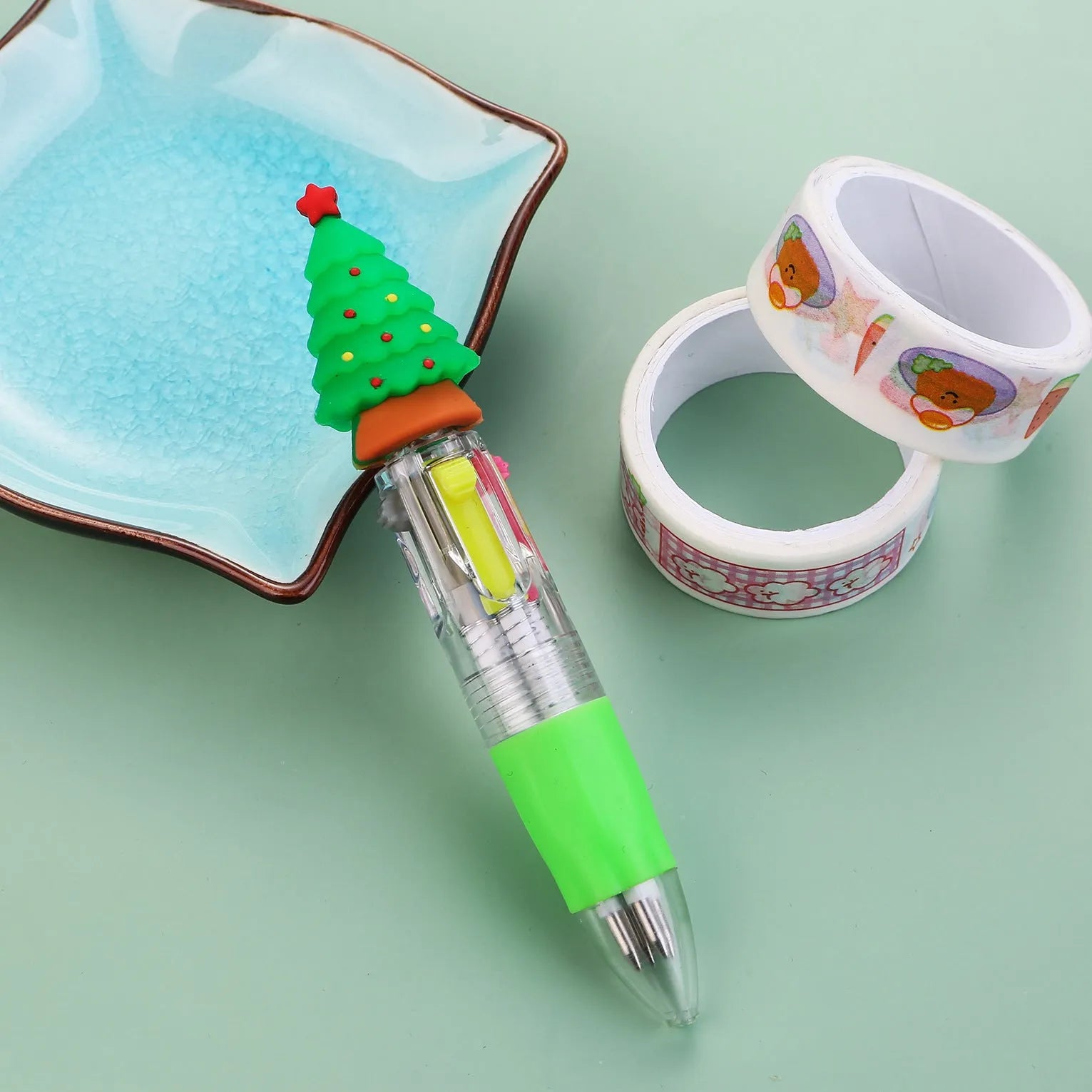 11cm long Christmas-themed four-colour ballpoint pen showing festive designs like reindeer and trees.