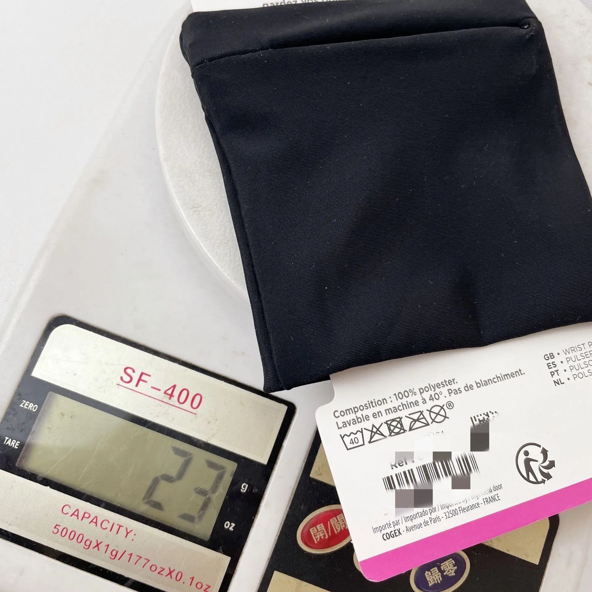 Black wrist bag armband sleeve for mobile phone, shown on an arm, dimensions 10cm by 10.5cm.