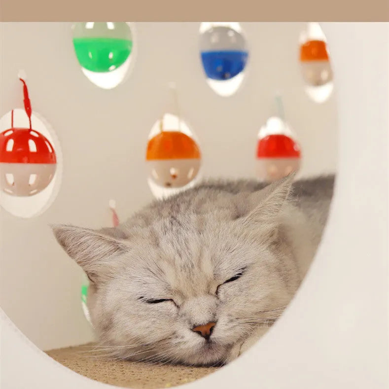 Plastic cat scratch board house with integrated tunnel containing bell ball and nest bed area
