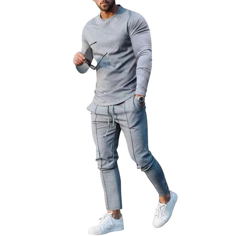 Men's light grey polyester two-piece suit with long sleeve t-shirt and trousers on a hanger.