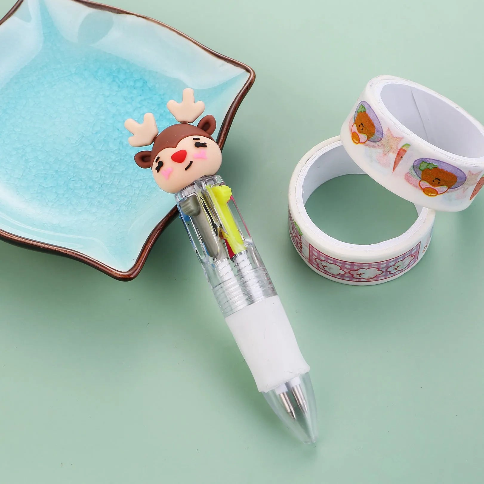 11cm long Christmas-themed four-colour ballpoint pen showing festive designs like reindeer and trees.