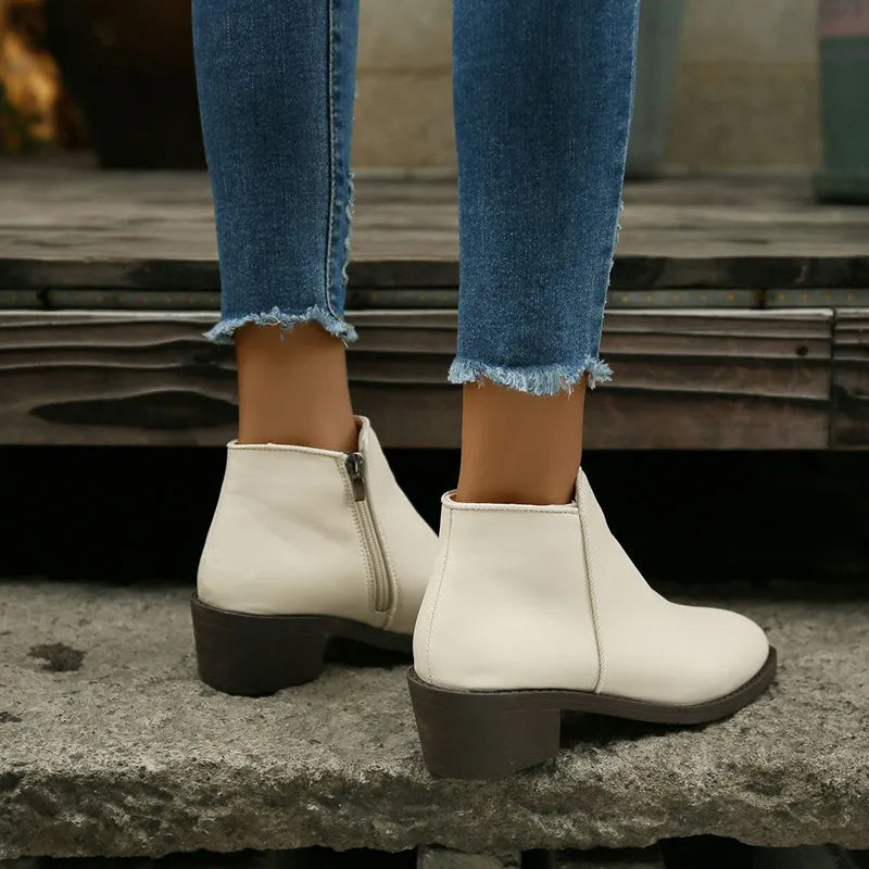 Women's chunky mid heel suede ankle boots with side zipper in off-white, front view