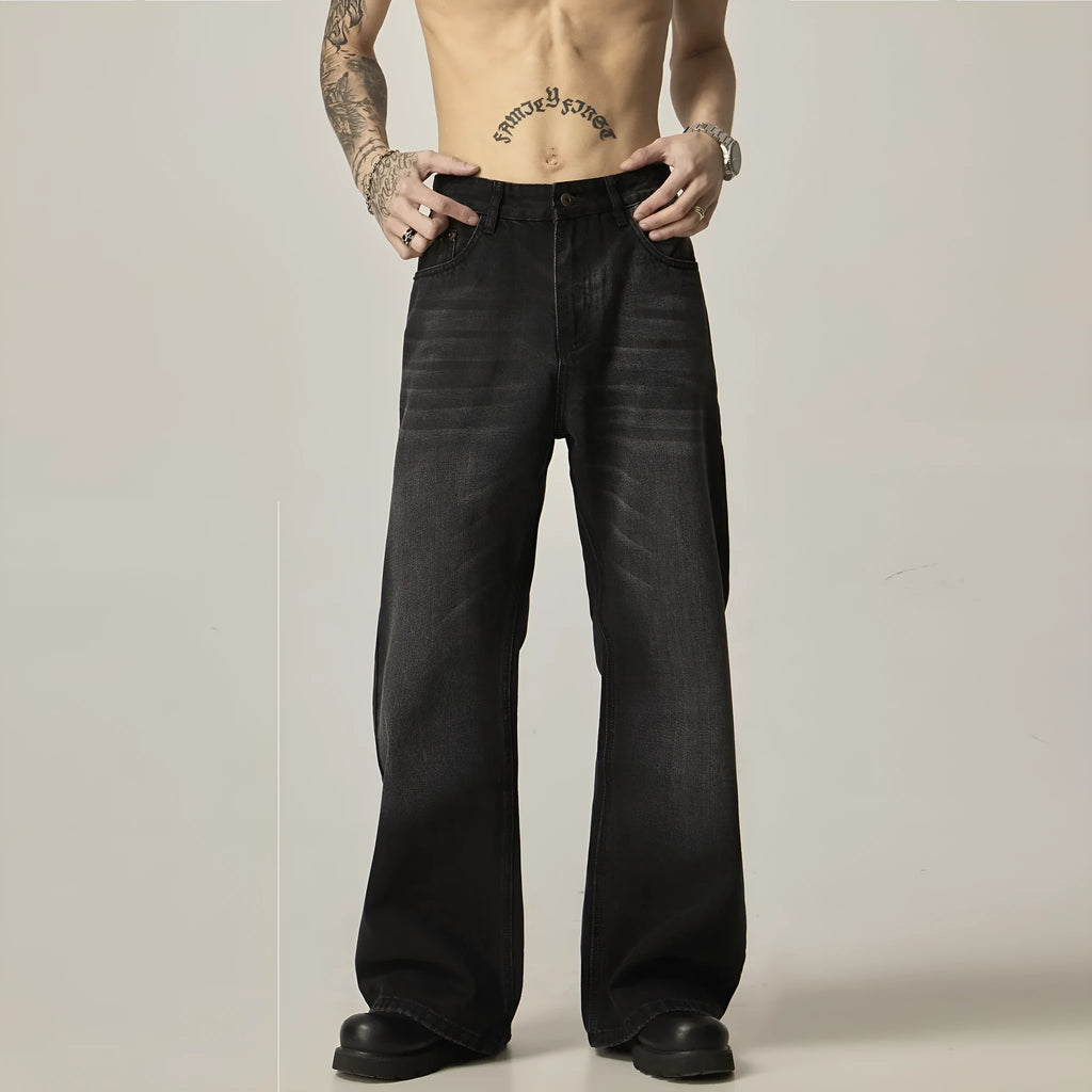 Black loose straight leg retro jeans on a hanger showing zipper fly detail