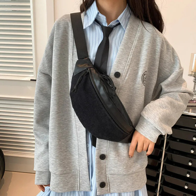 Corduroy crossbody bag in oval shape with brown colour, slit outer pocket, and crossbody strap for daily use