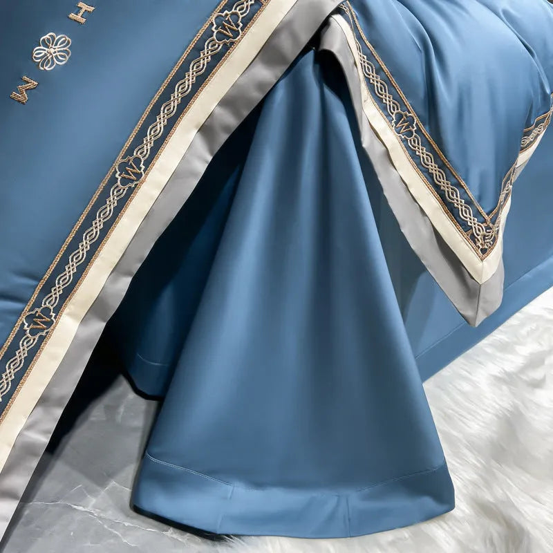All-cotton light luxury four-piece bedding set with embroidery, available in multiple colours, on a bed