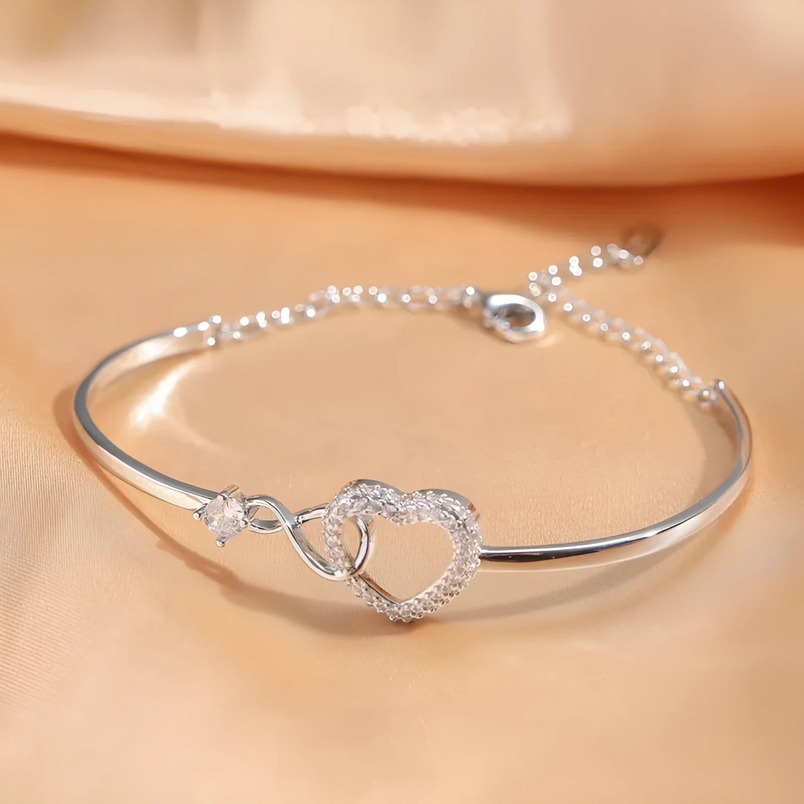 Hollow zircon loving heart opening bracelet in silver finish on copper base with electroplating