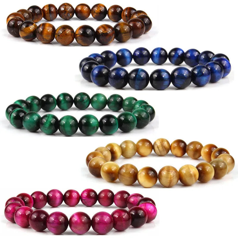 Natural tiger eye crystal bracelet with round beads in various colours on a wrist.