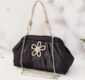 Women's soft shell-shaped polyester messenger bag in black with decorative chain and diamond details