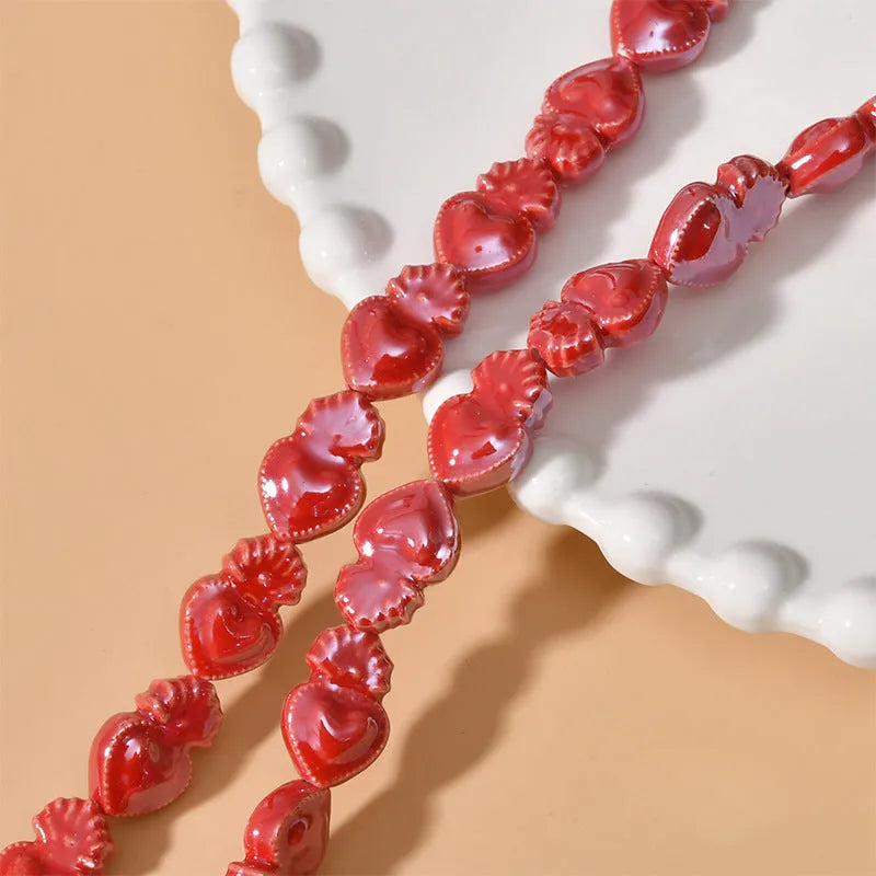 Assorted small ceramic torch beads in multiple colours on a white background.