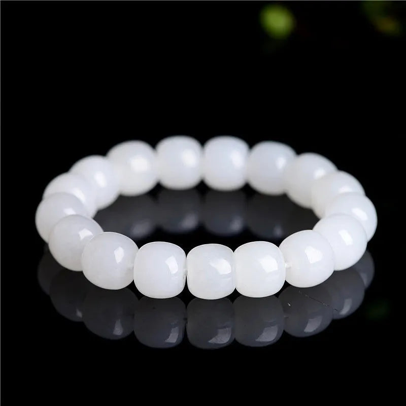 White Hetian jade barrel beads bracelet laid flat, showing unisex design and bead detail.