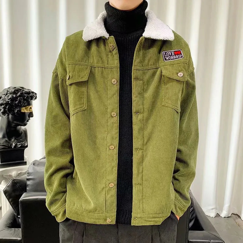 Man wearing a loose-fit khaki corduroy work jacket with side pockets.