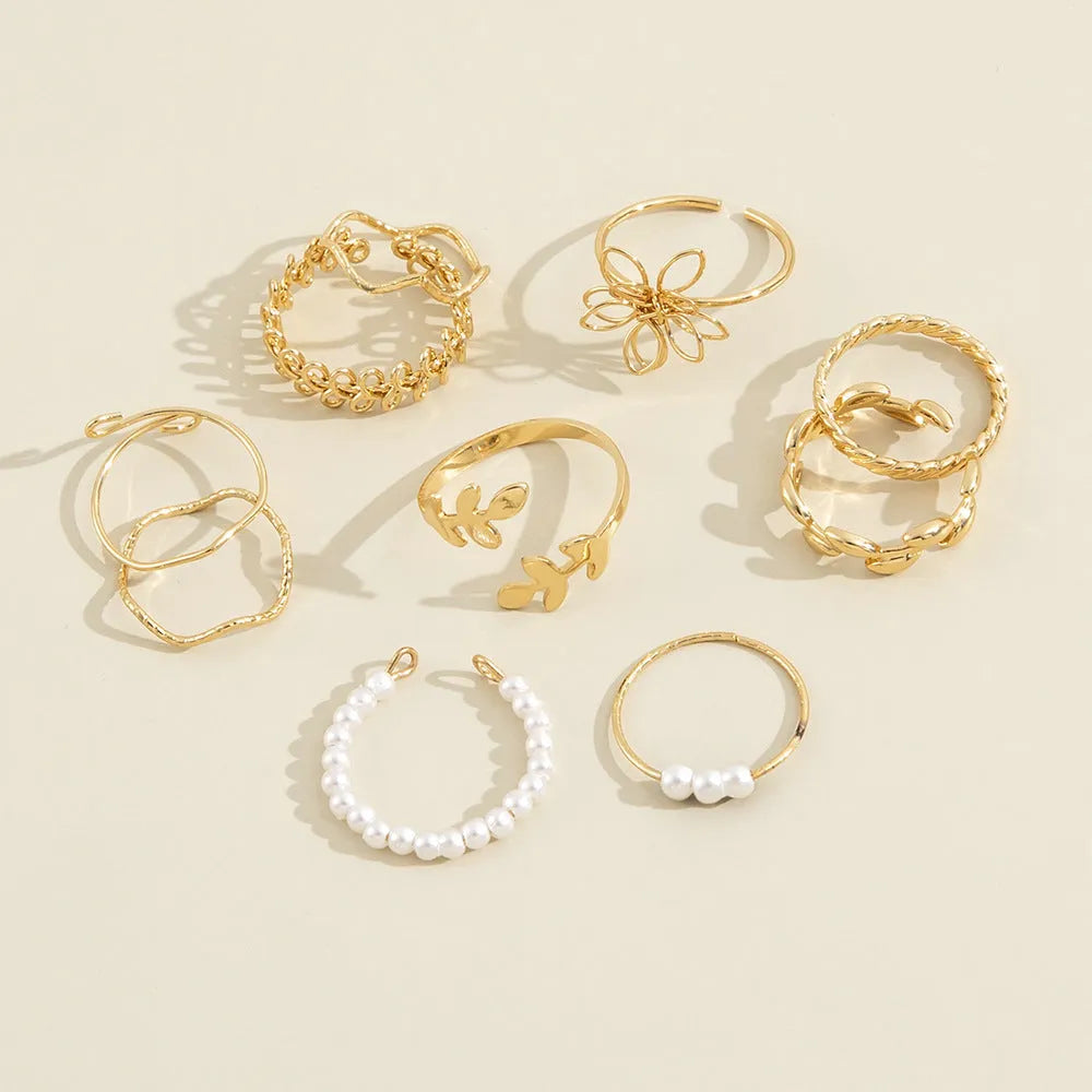 Gold-coloured alloy ring with openwork floral design and glossy electroplated finish
