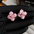 Gold plated flower stud earrings with a purple oil-spot glaze finish on copper.