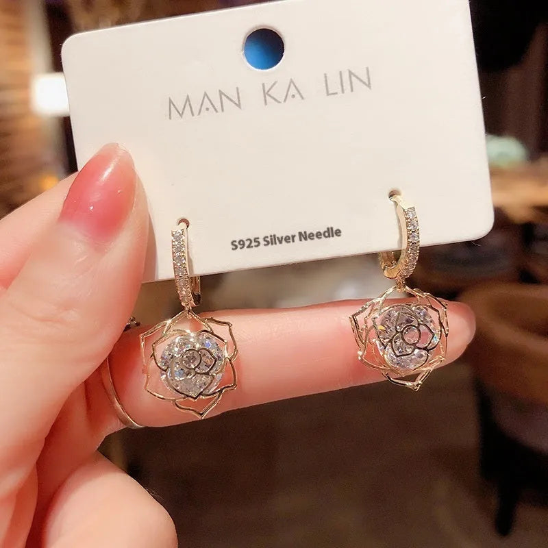 Geometric copper earrings with rose design elements and zircon detail in silver electroplated finish